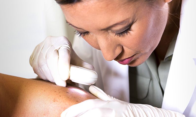 Dermatologist analyzing skin